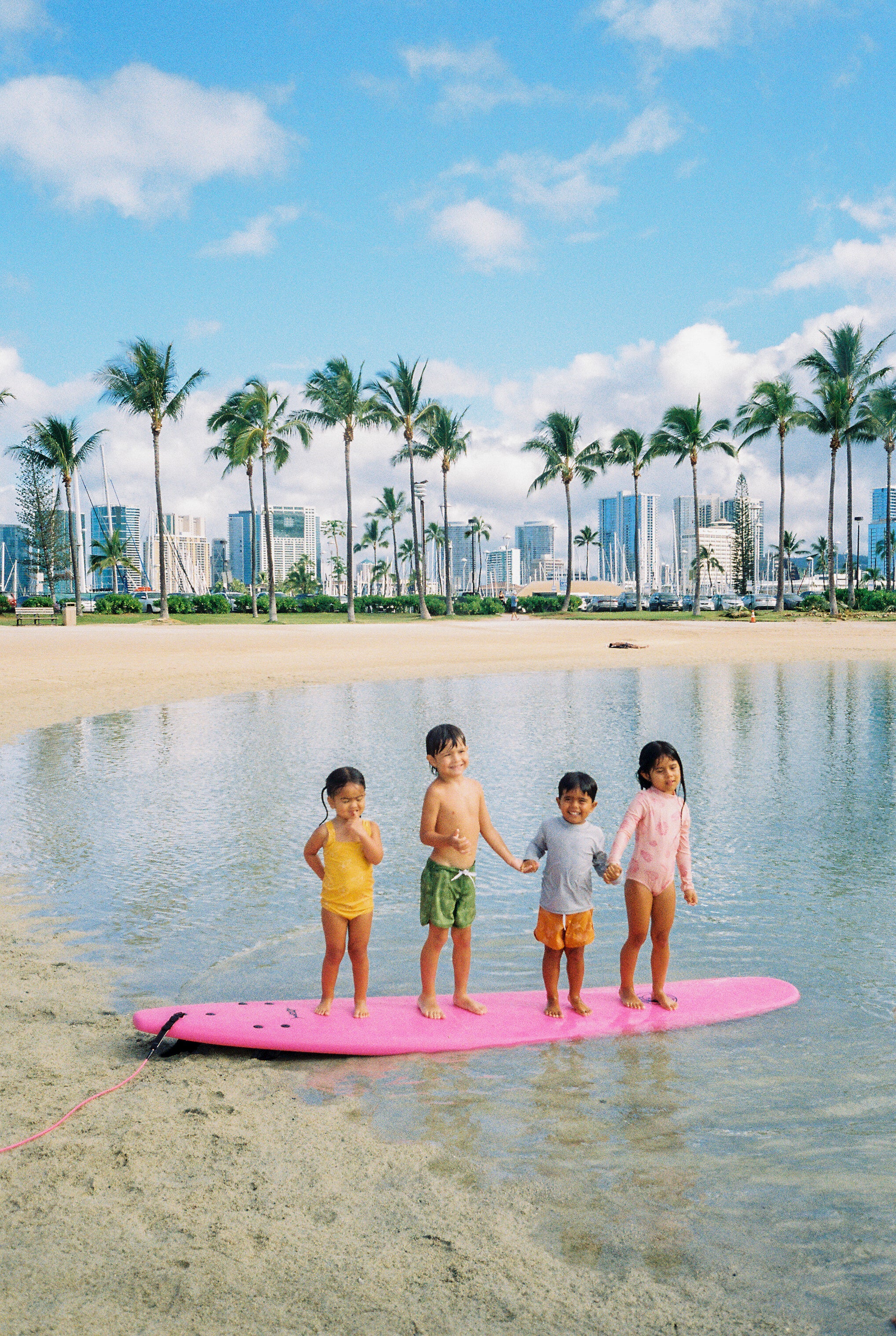 Children standing on a surfboard