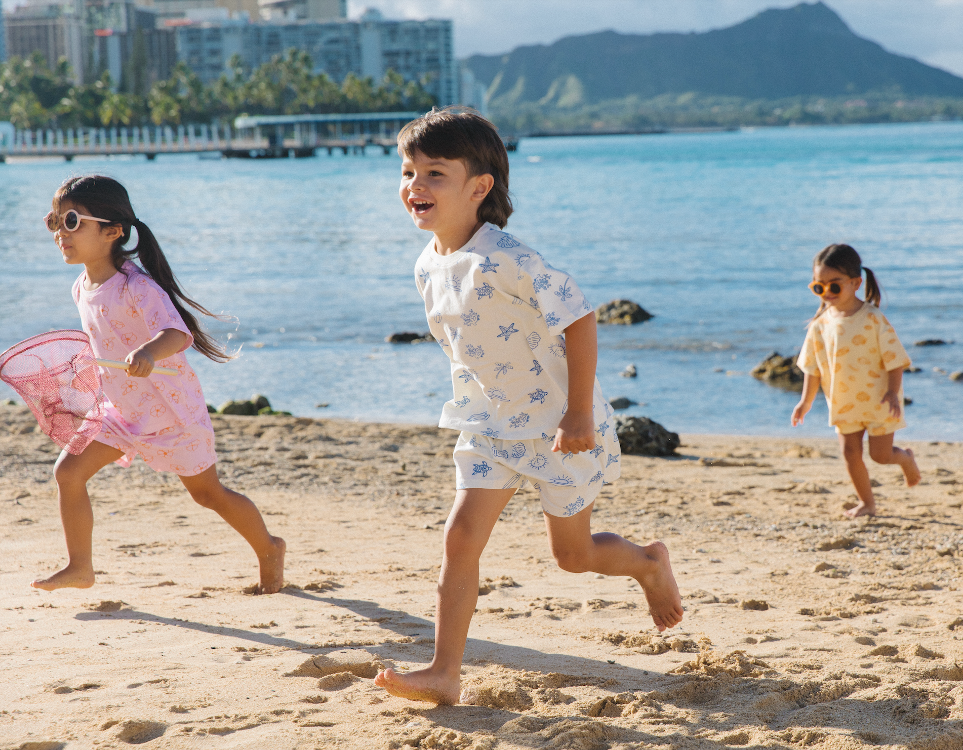 Children running playfully on the beach